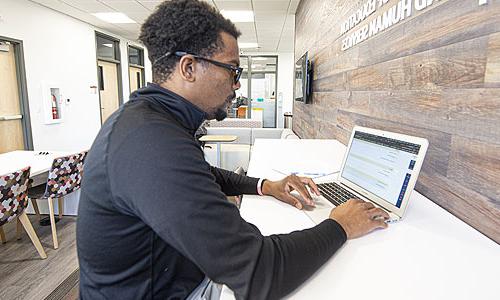 A student working at a laptop